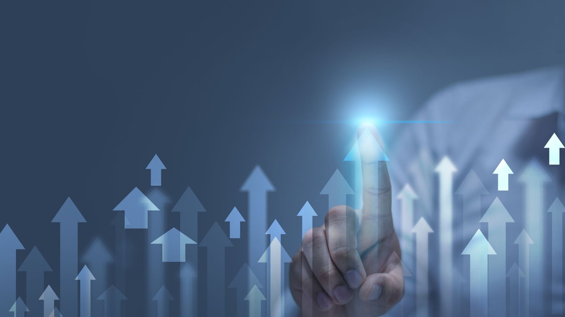 Hand touching rising arrows, representing business growth and success