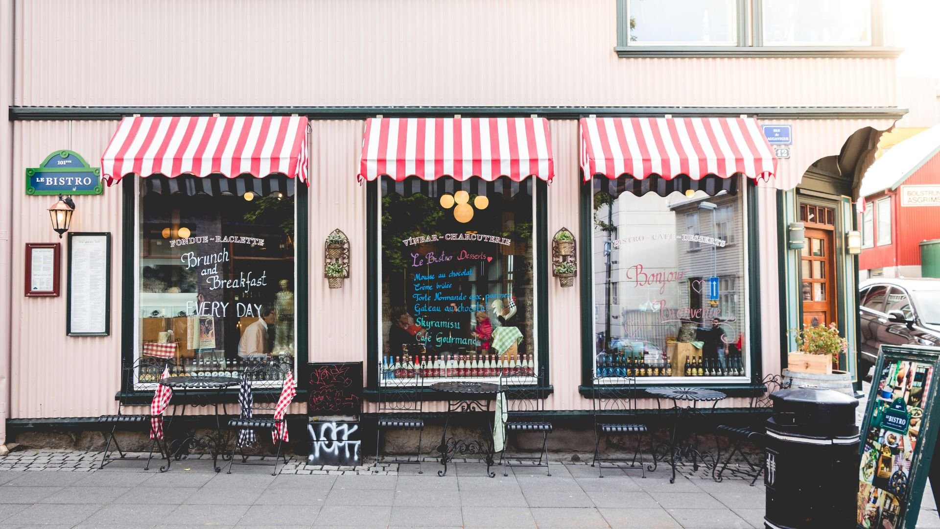Charming French bistro with red-and-white striped awnings and window displays